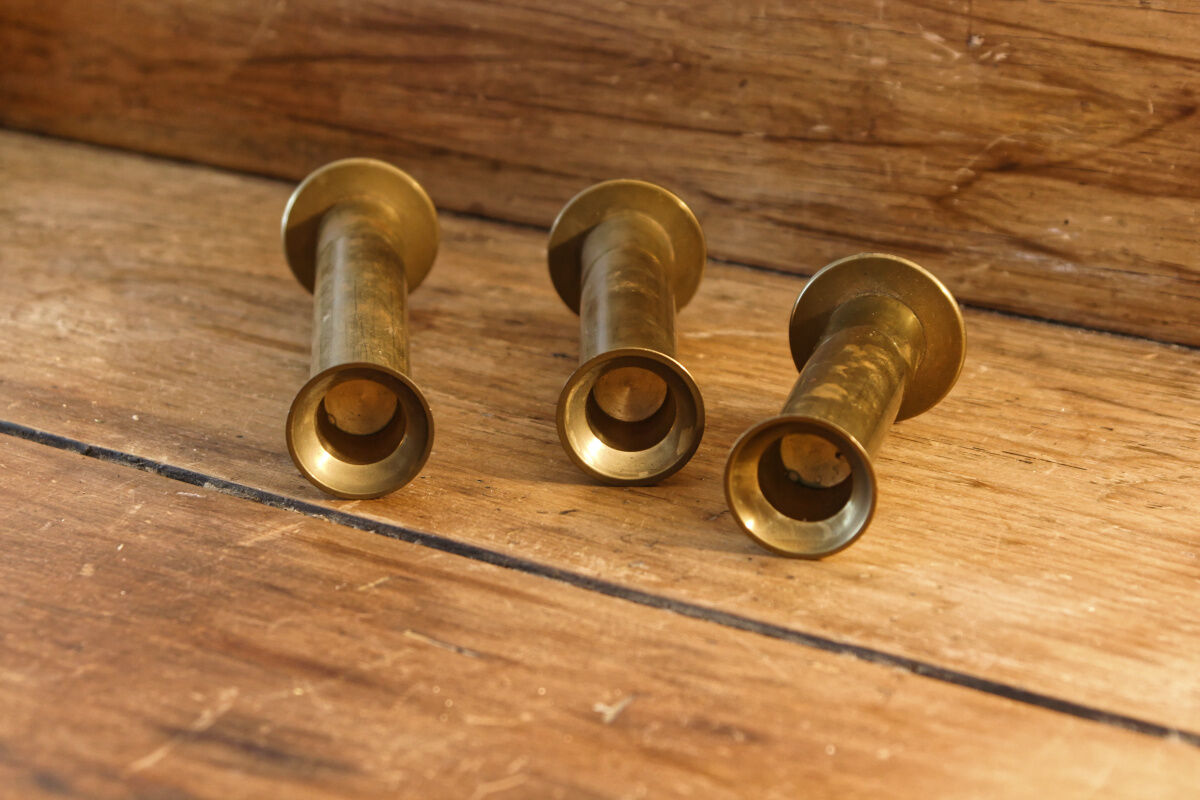 Trio of brass candle holders