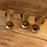 Trio of brass candle holders
