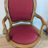 Vintage captain's chair in wood and garnet fabric — a seat with character