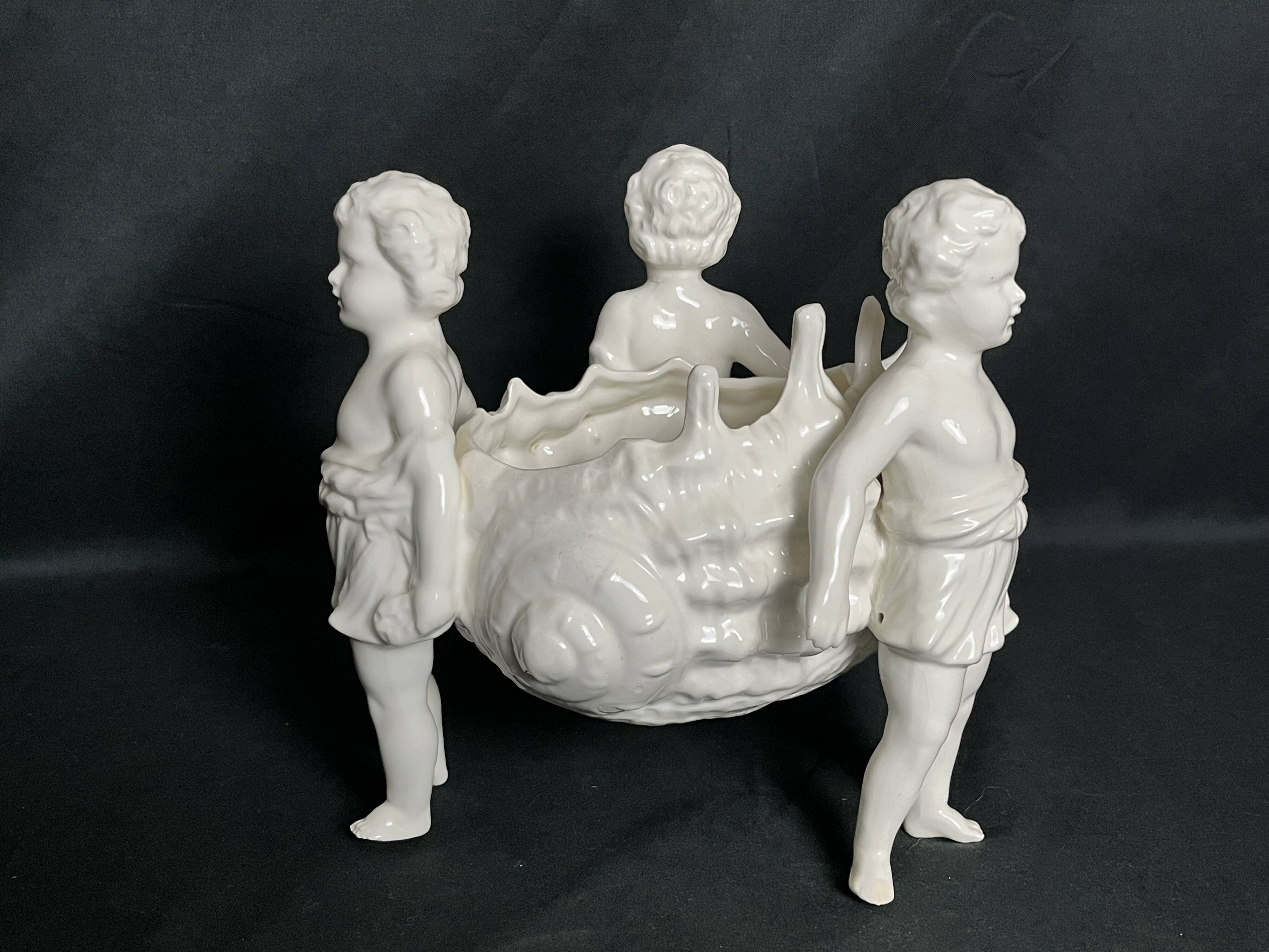 Porcelain, centerpiece with candle holder decorated with putti, 20th century