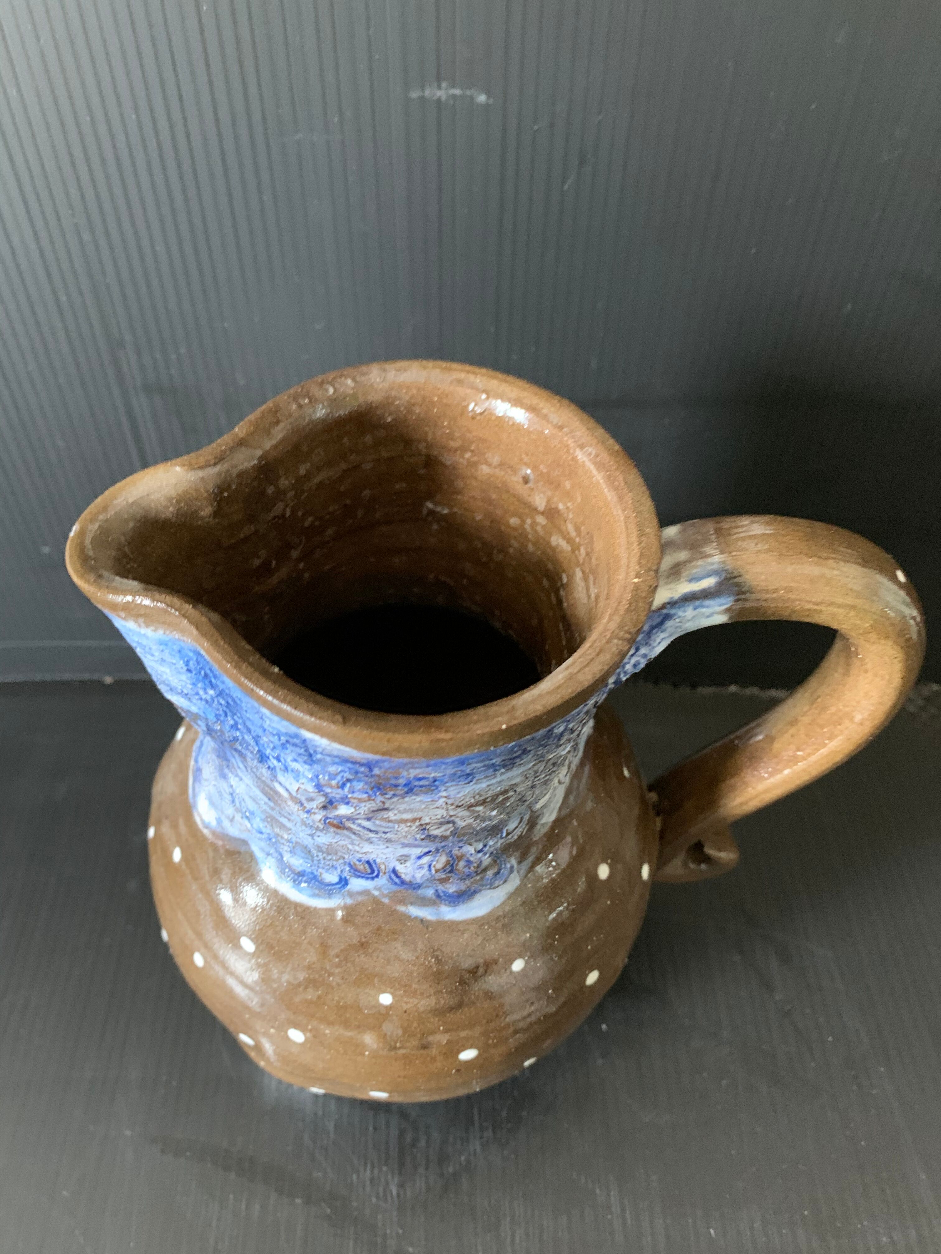 Brown enamelled ceramic pitcher with polka dots