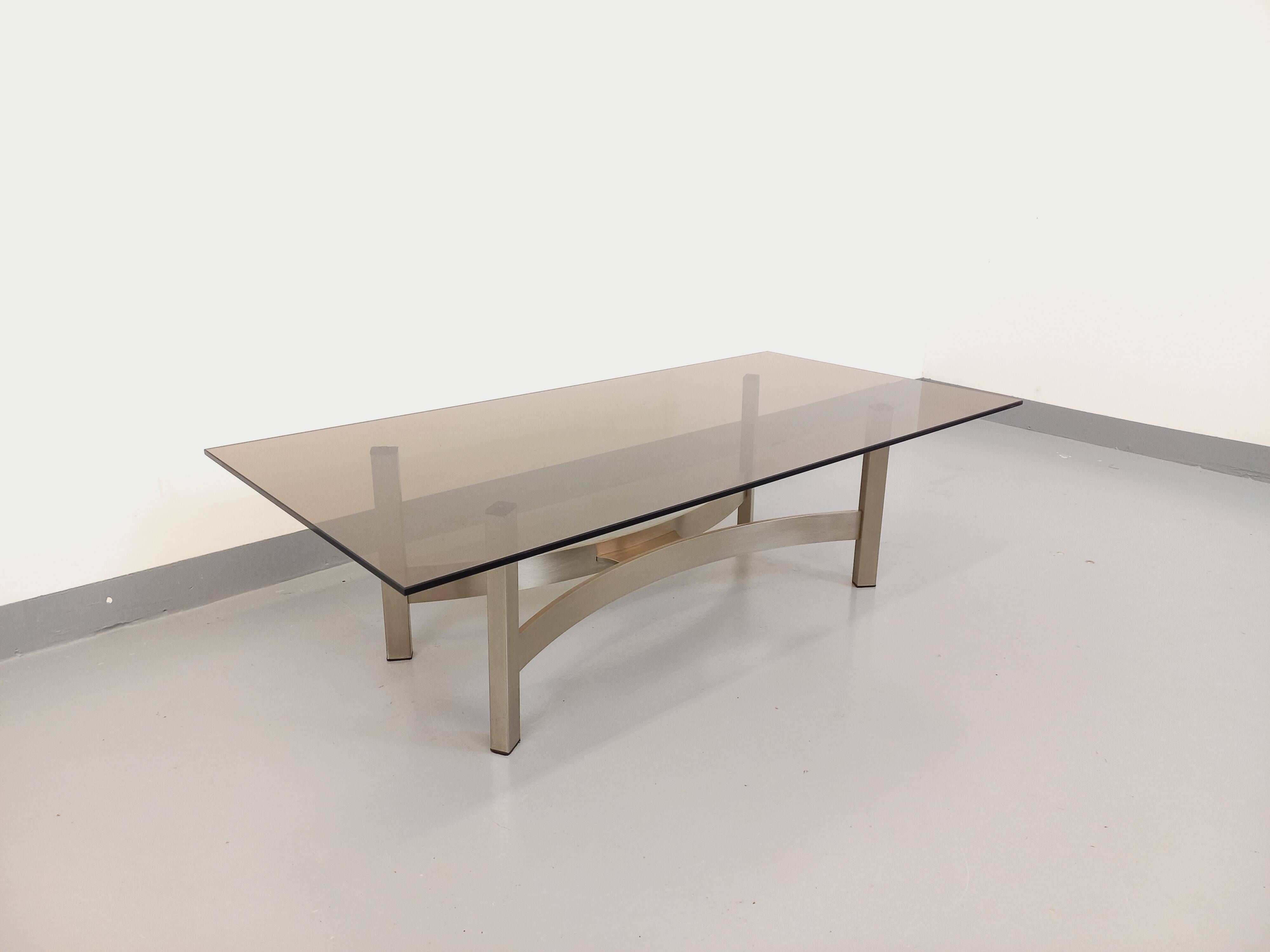 Vintage coffee table in smoked glass and brushed cast aluminum from the 70s