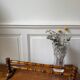 Wall-mounted coat rack made of turned wood in a bamboo style.