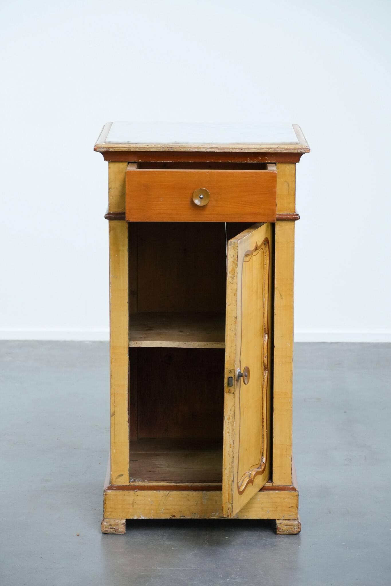Antique wooden 1-door hallway/nightstand with a light marble top