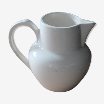 Old pitcher in white earthenware