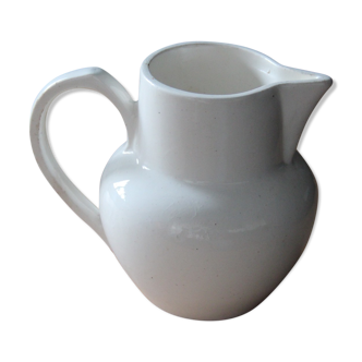 Old pitcher in white earthenware