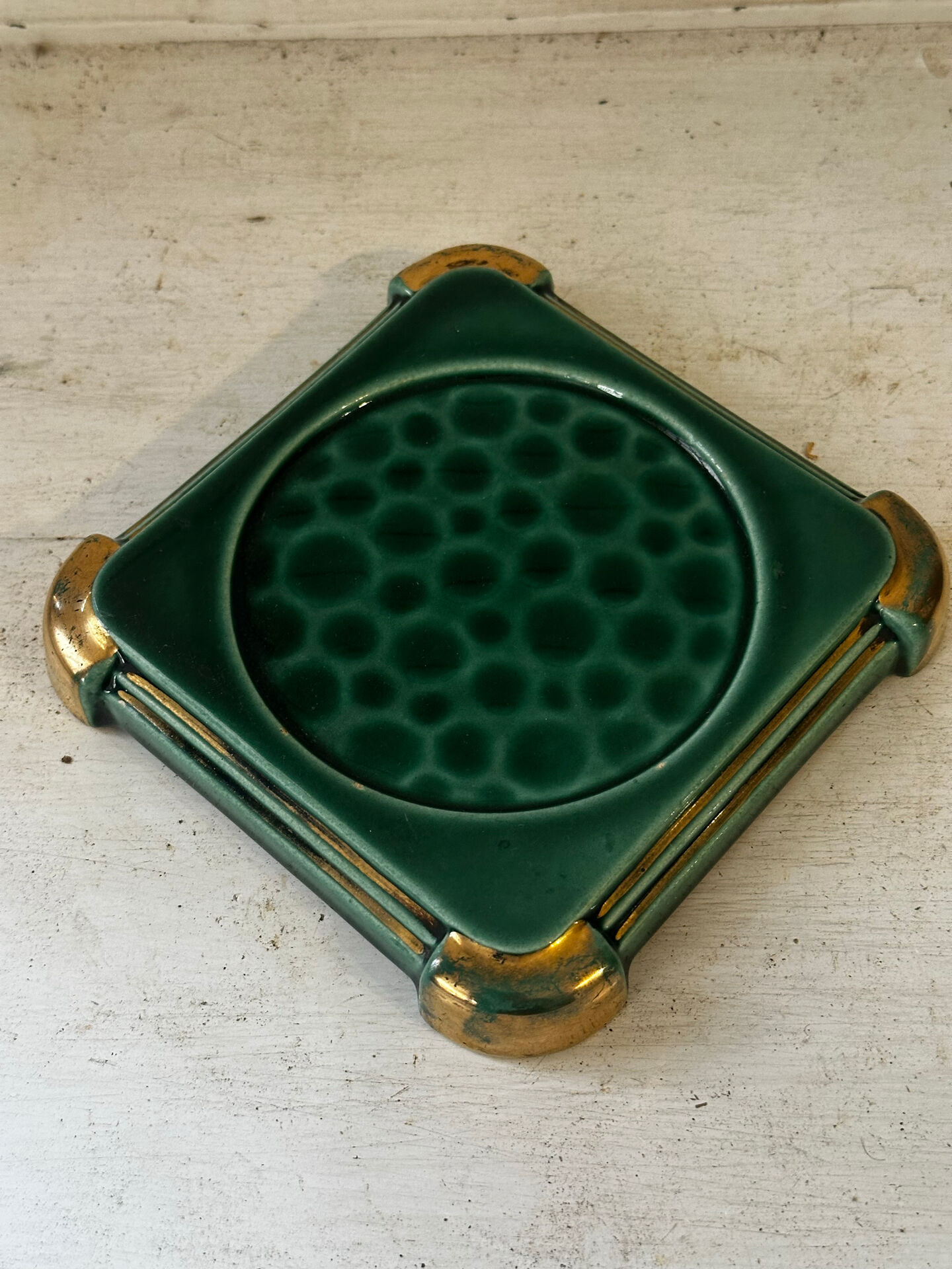 Art Deco bottle coaster in speckled green glazed ceramic and