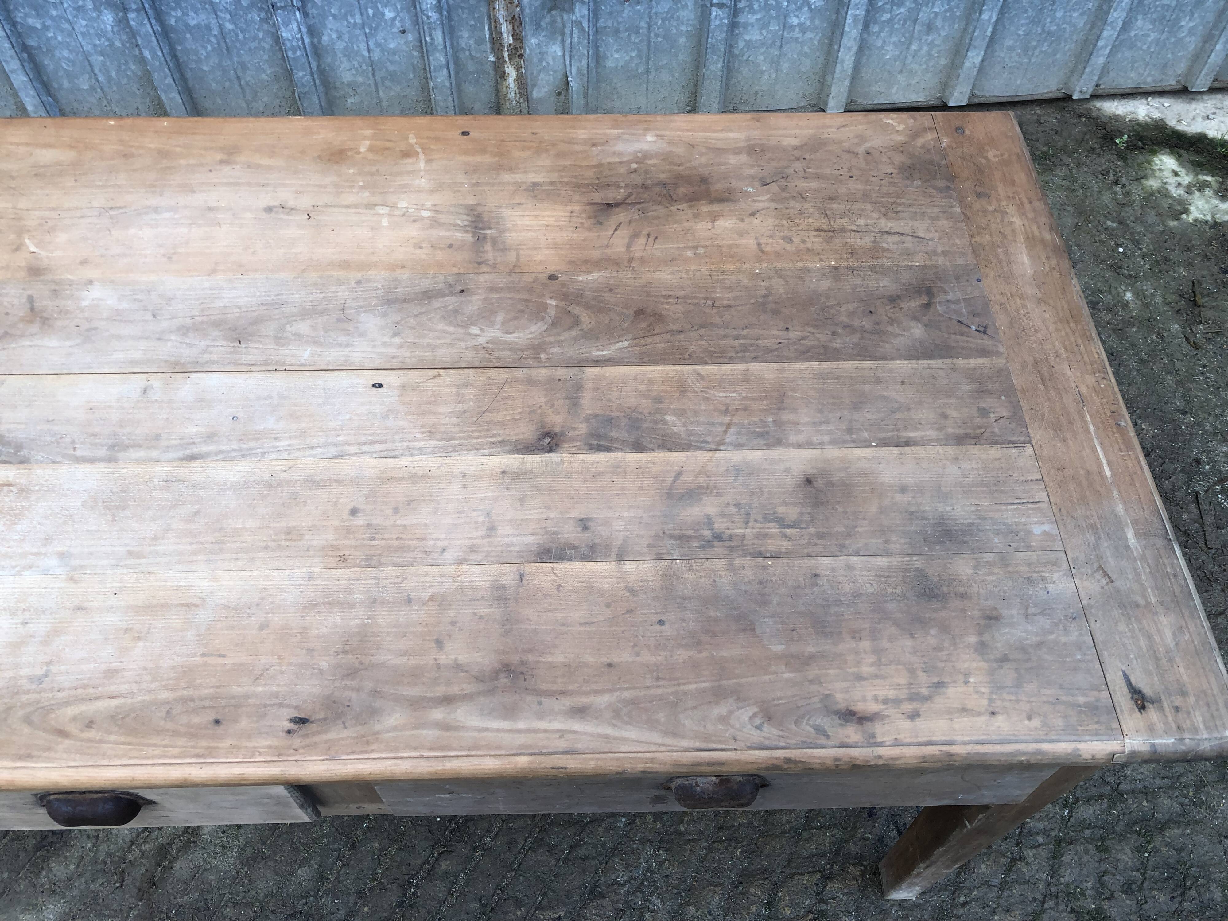 Antique solid cherry farm table with 3 front drawers.