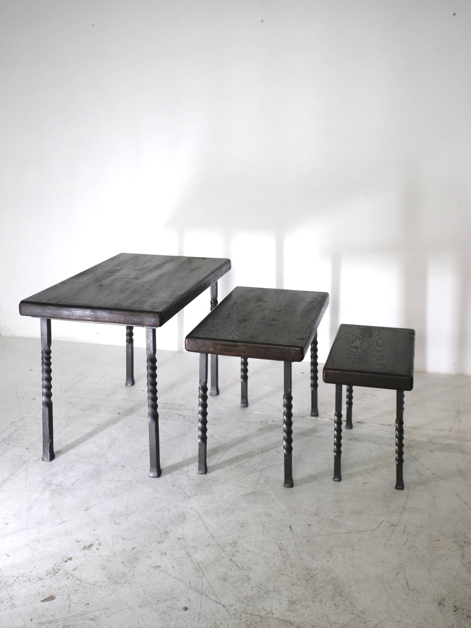 Brutalist nesting table in ebonized oak and wrought iron
