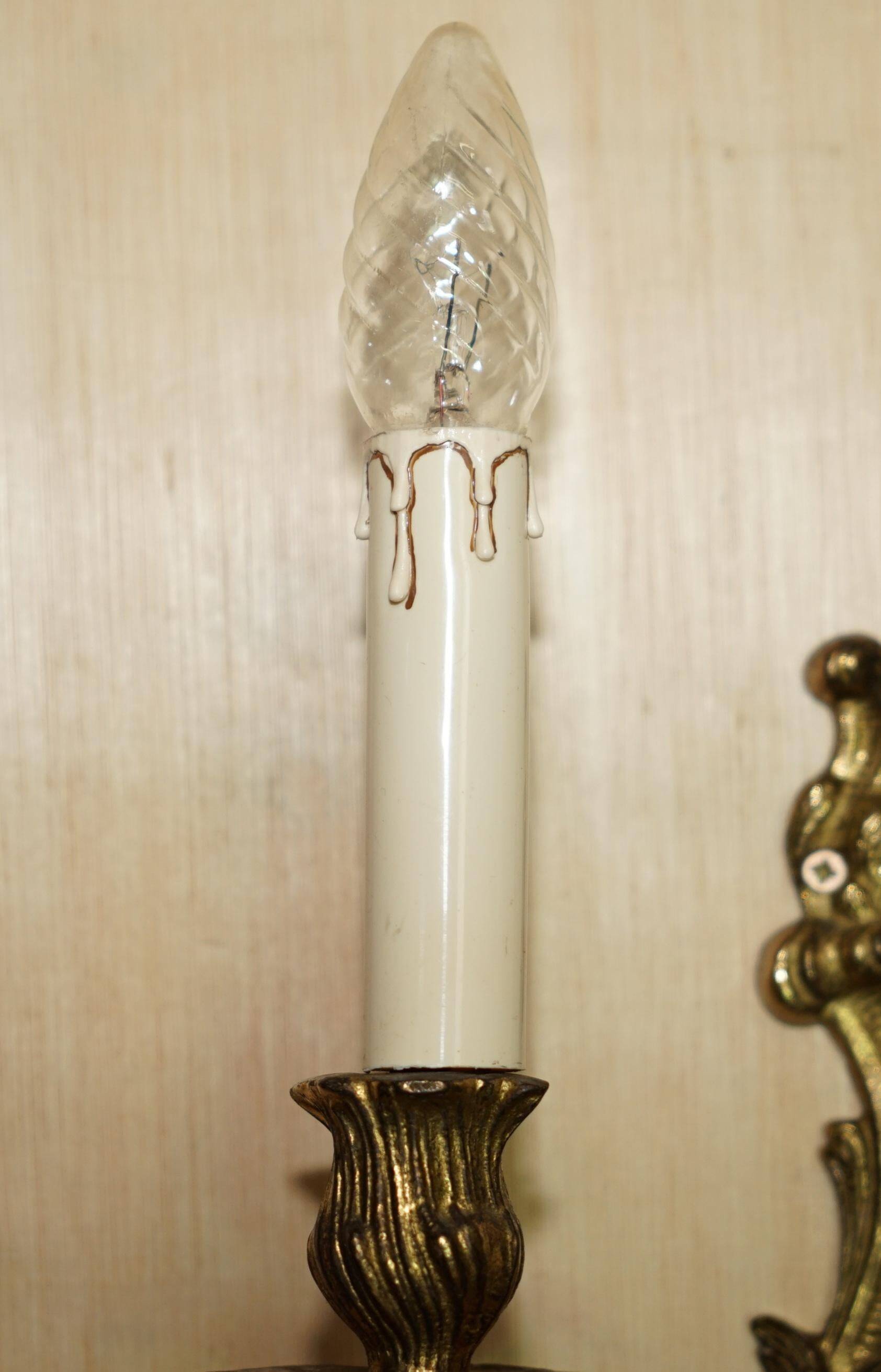 Pair of antique wall sconces from the 1920s in gilded bronze.