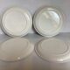 Four vintage floral cheese plates.