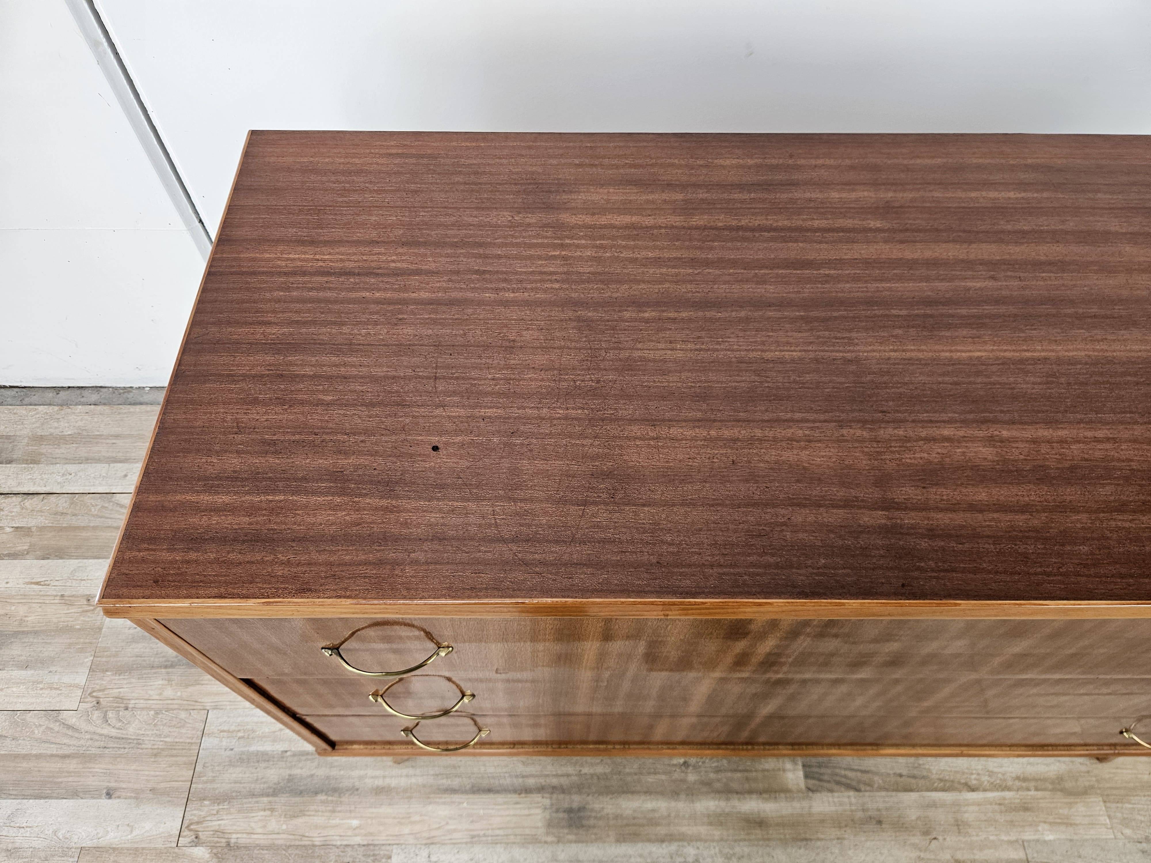 1950s chest of drawers covered in walnut with brass handles