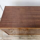 1950s chest of drawers covered in walnut with brass handles