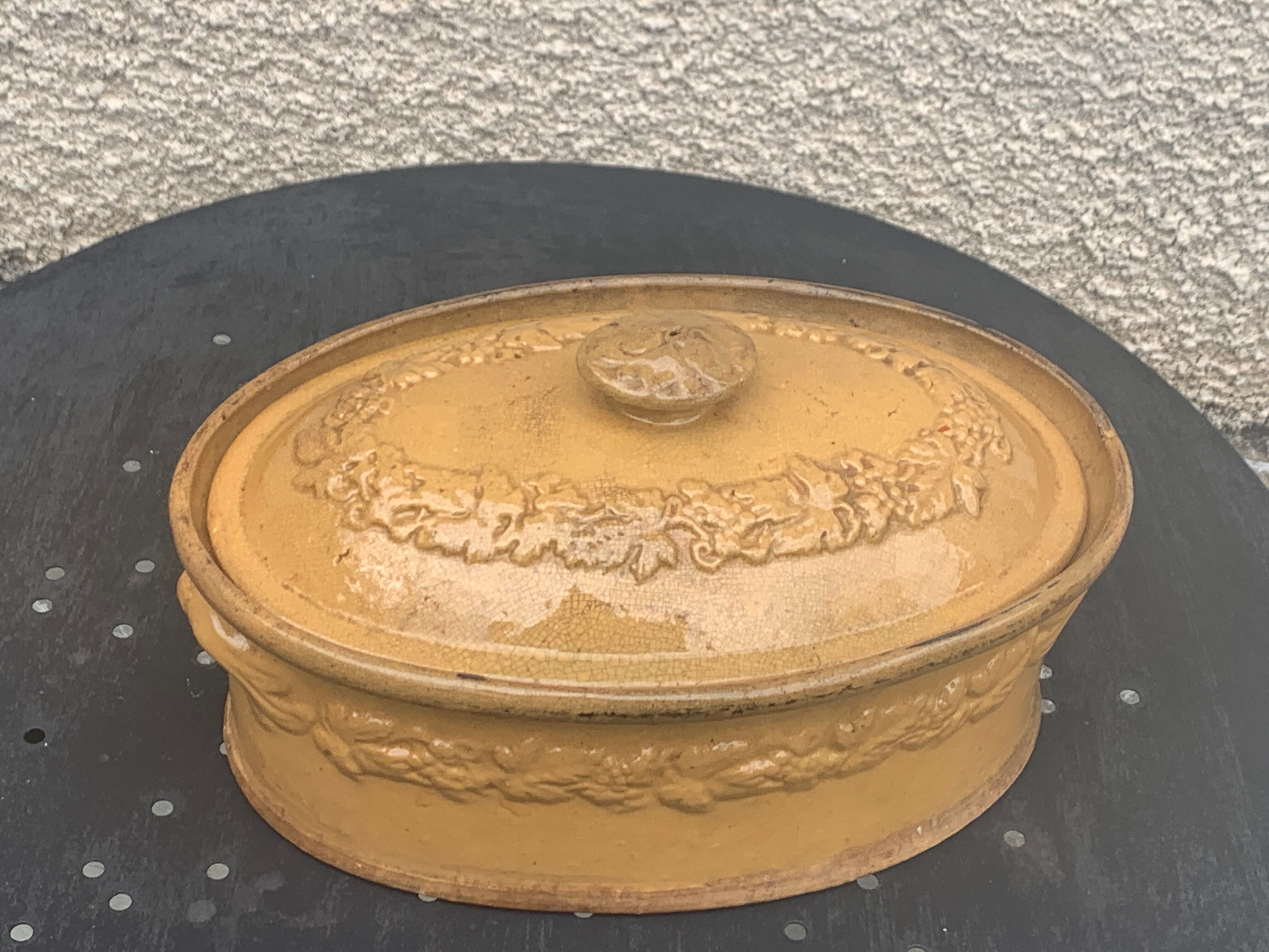 Old terrine in glazed stoneware and floral decoration mustard yellow slip
