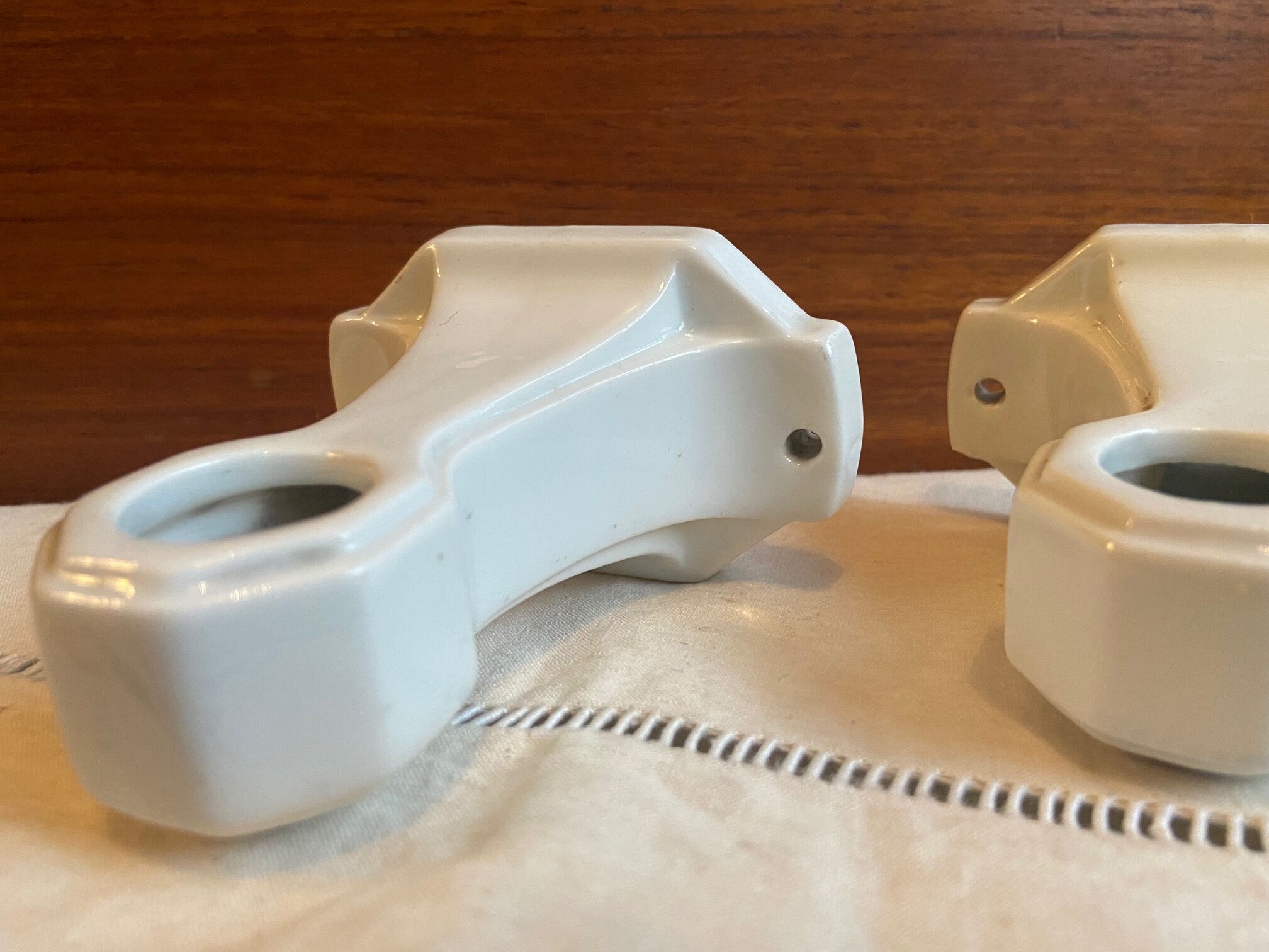 Pair of white earthenware wall candlesticks