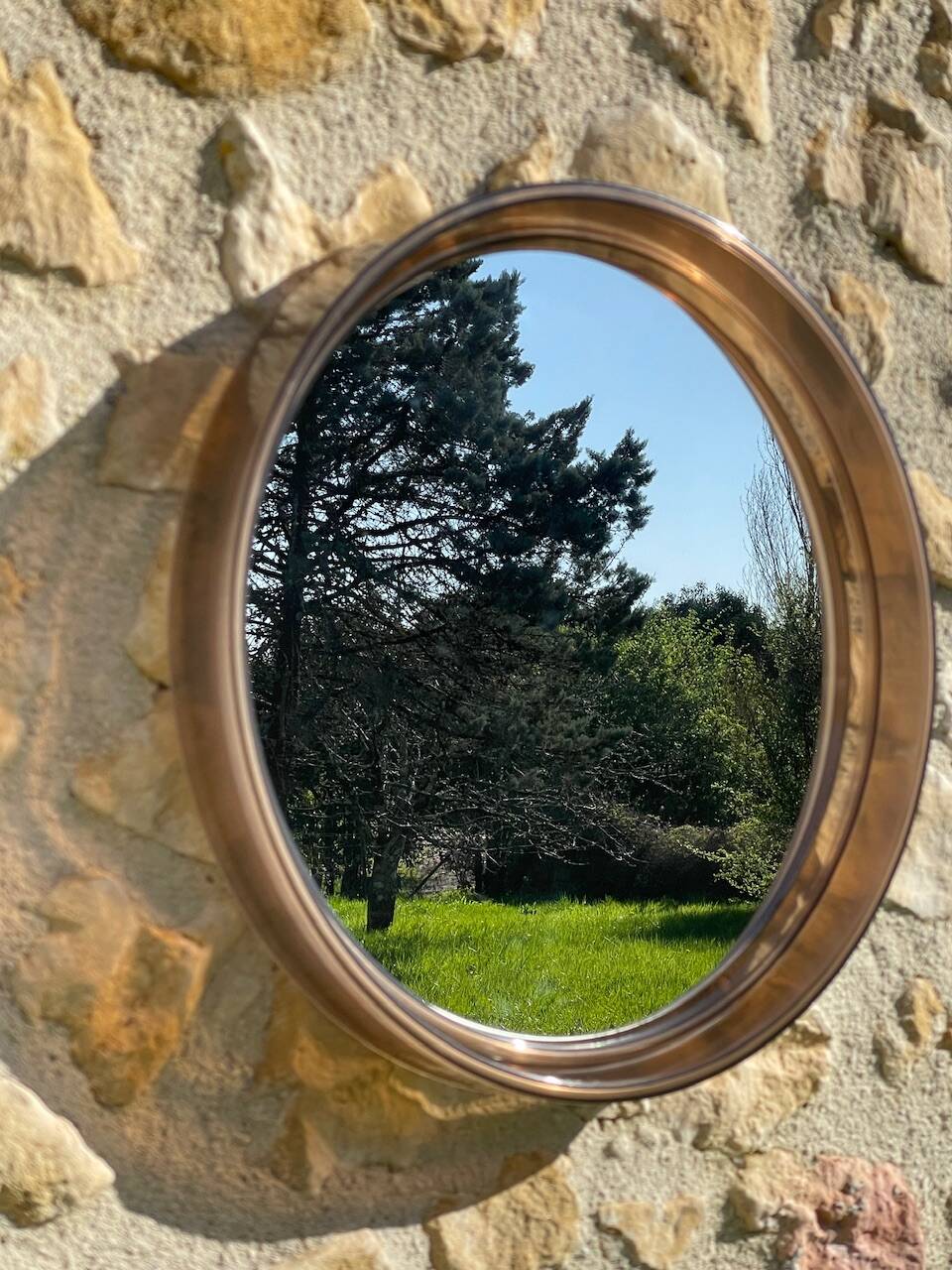Vintage round smoked plastic mirror, circa 1970s.