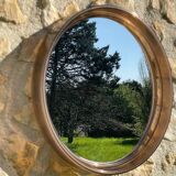 Vintage round smoked plastic mirror, circa 1970s.