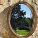 Vintage round smoked plastic mirror, circa 1970s.