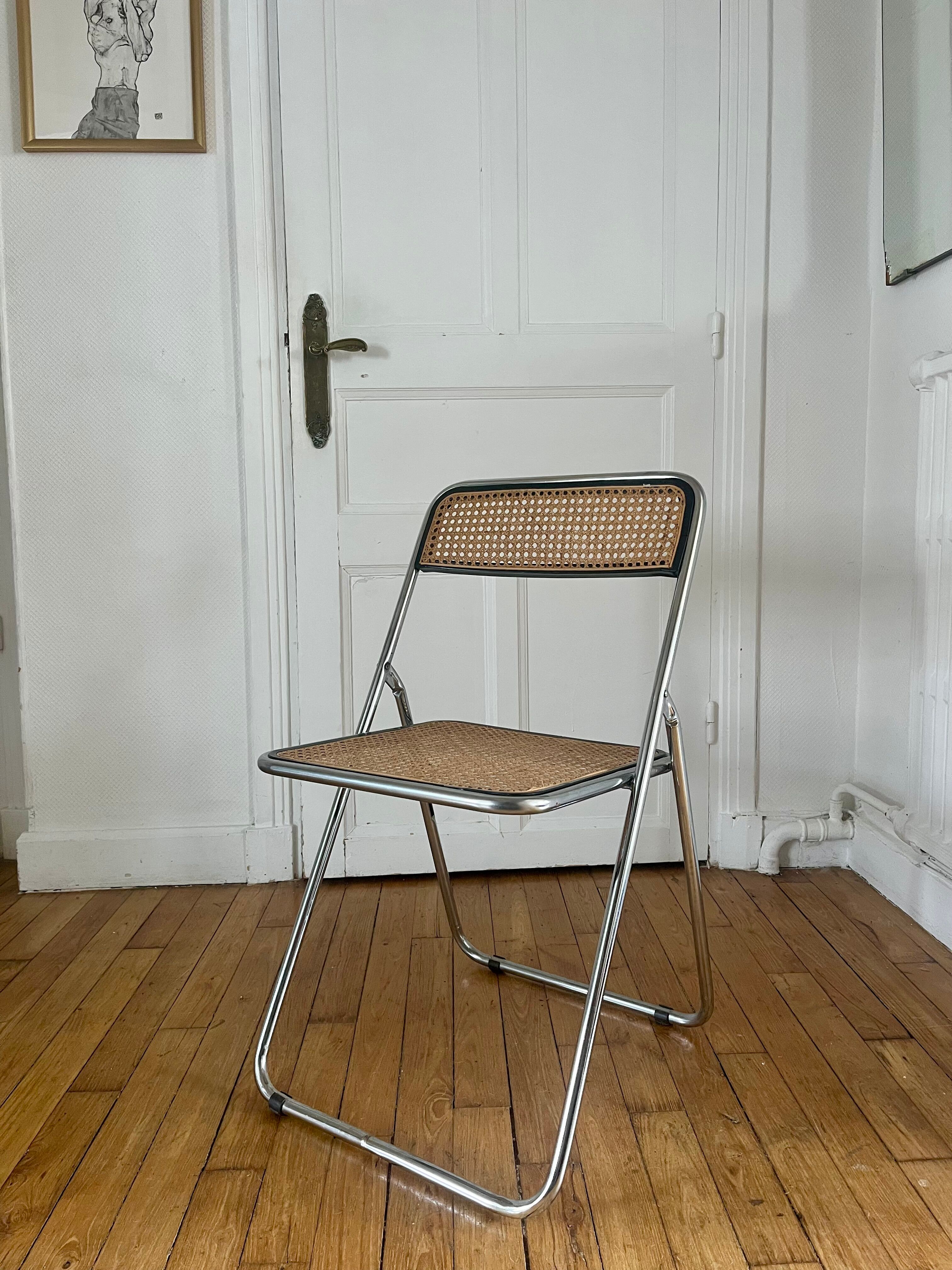 Vintage folding chair in metal and cane.