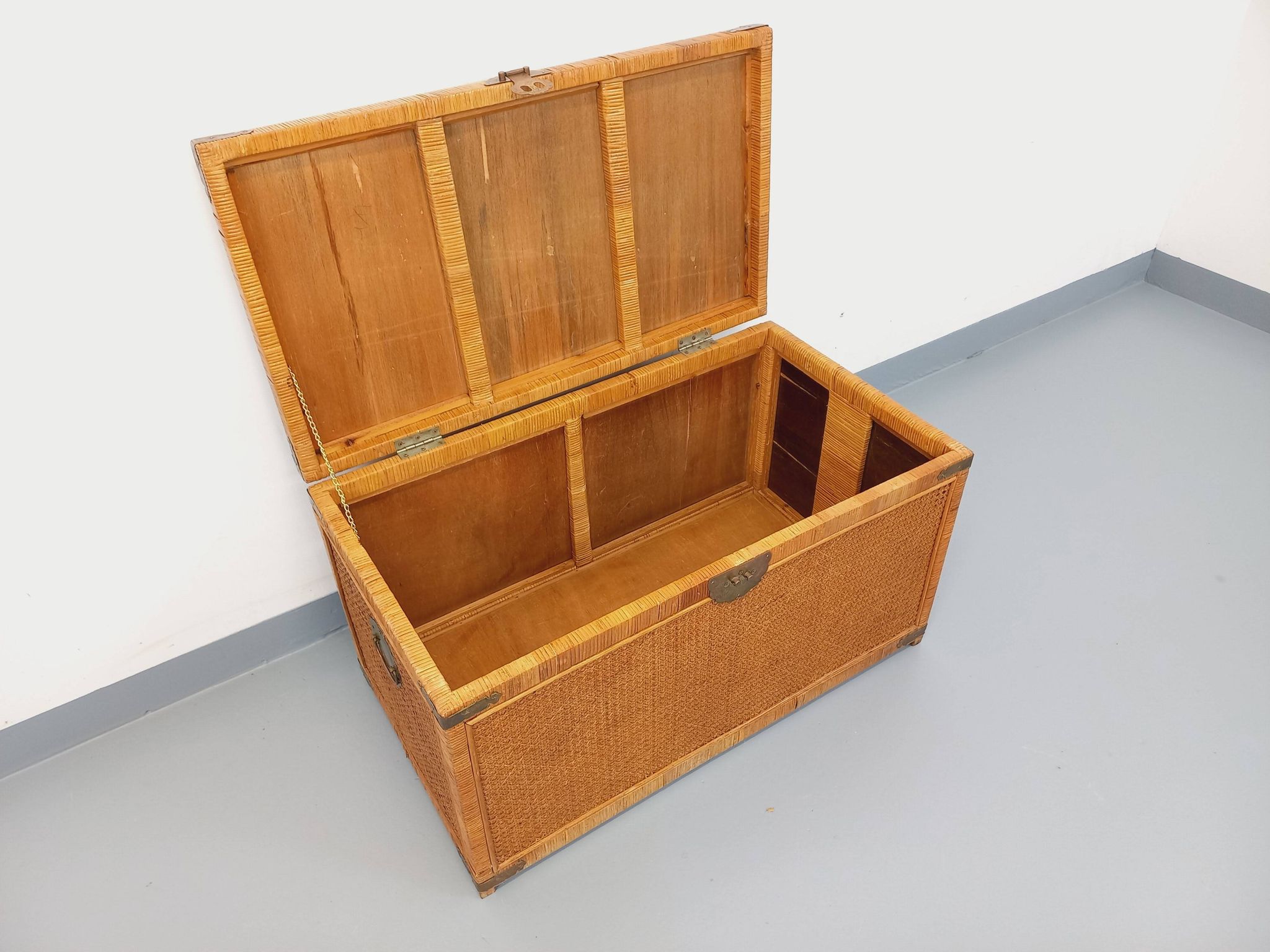 Vintage trunk in wood, rattan, caning, and brass.