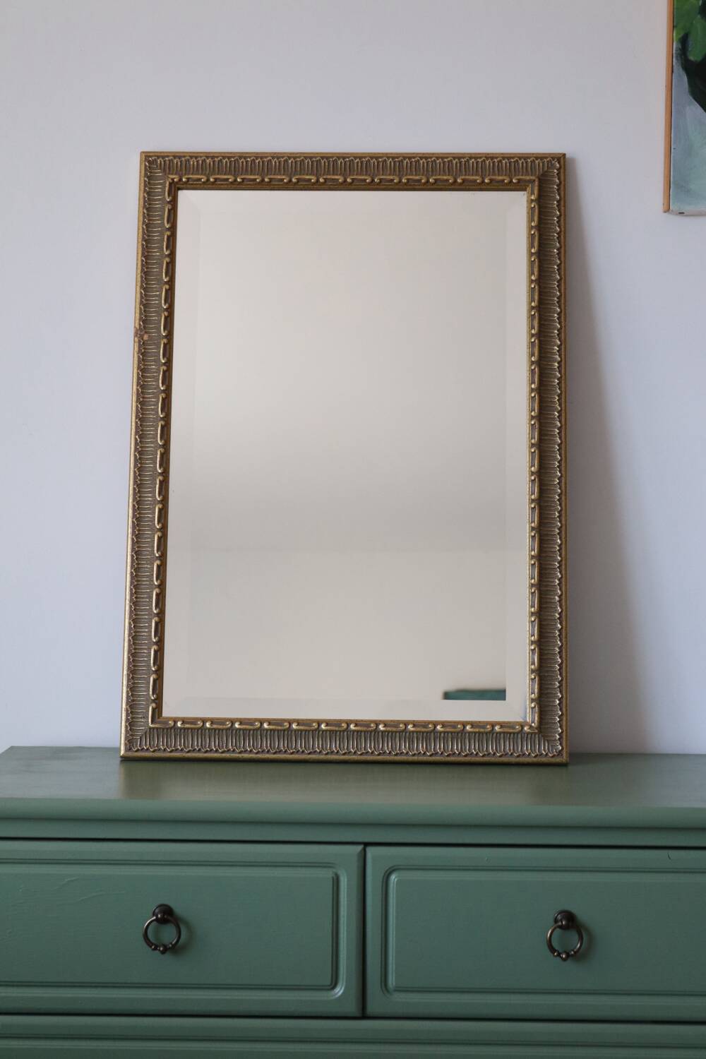 Rectangular gold mirror with moulded decoration.