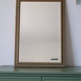 Rectangular gold mirror with moulded decoration.