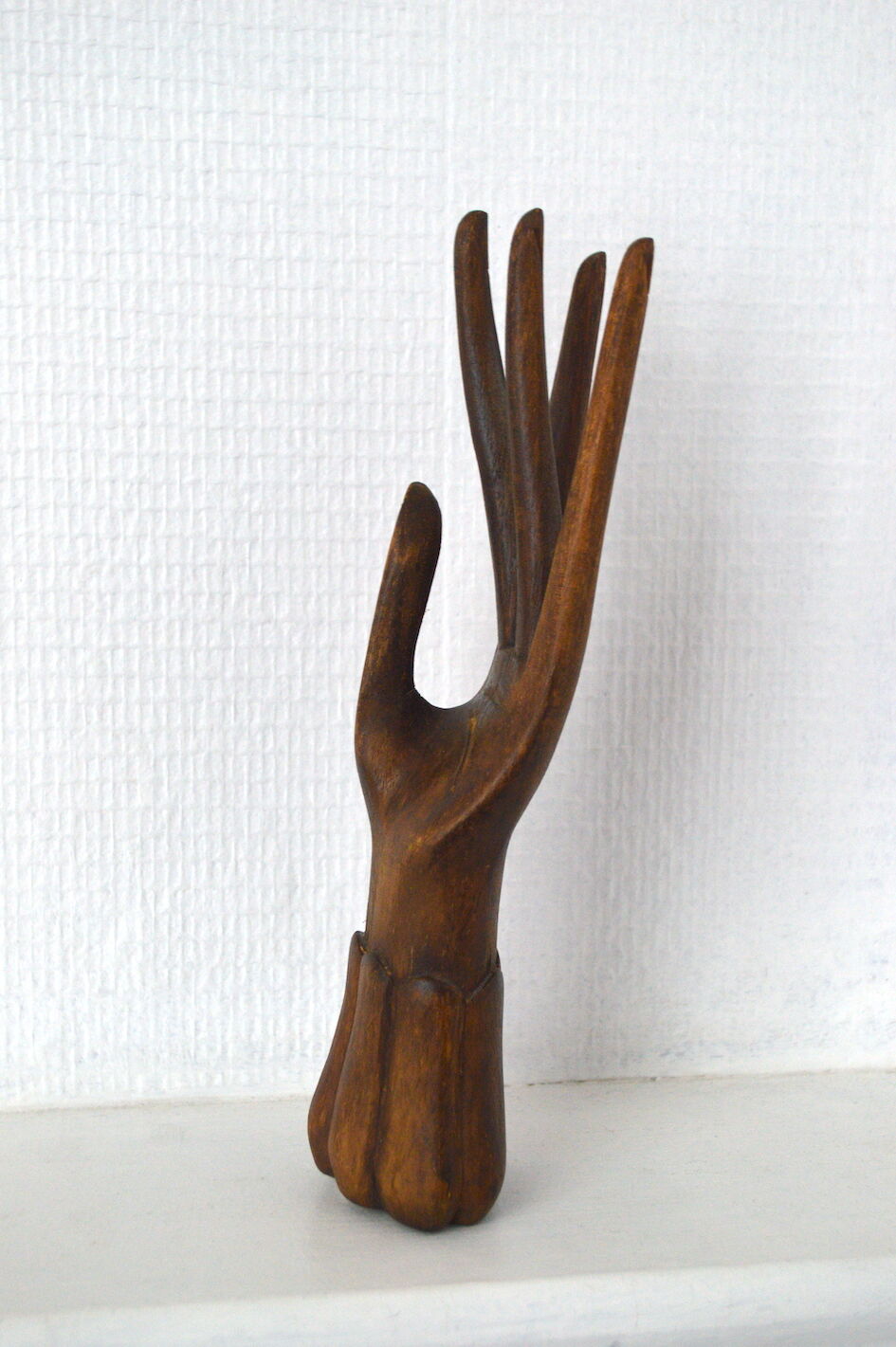 Carved wooden baguier hand