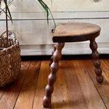 Low vintage wooden tripod stool