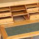 Sloped wooden desk in light wood, ideal for remote work. Secret drawer.