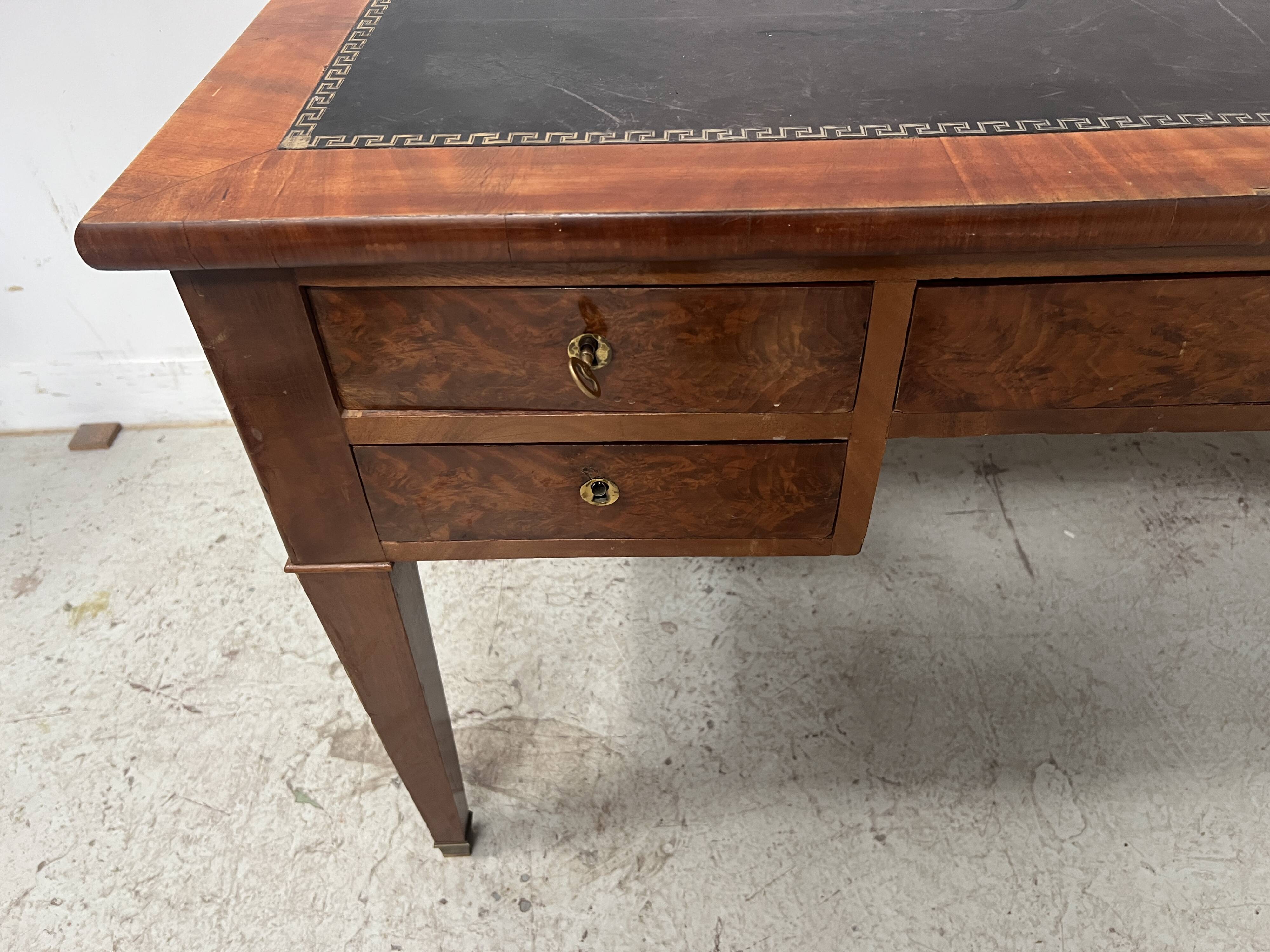 Louis XVI style flat desk in walnut and veneer, 19th century.
