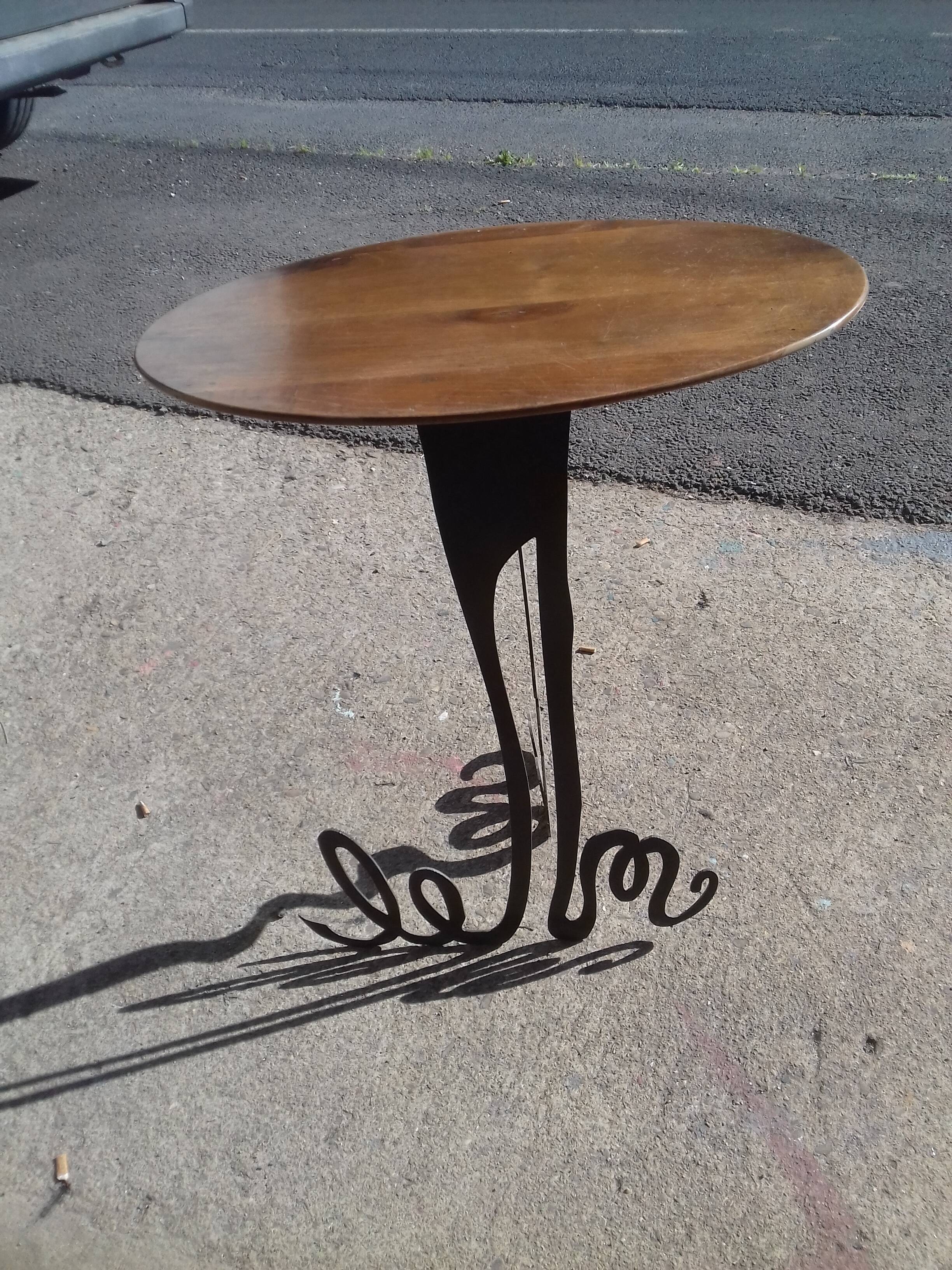 Steel side table with an oval walnut top