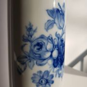 White porcelain vase from Limoges with blue decoration and gold rim.