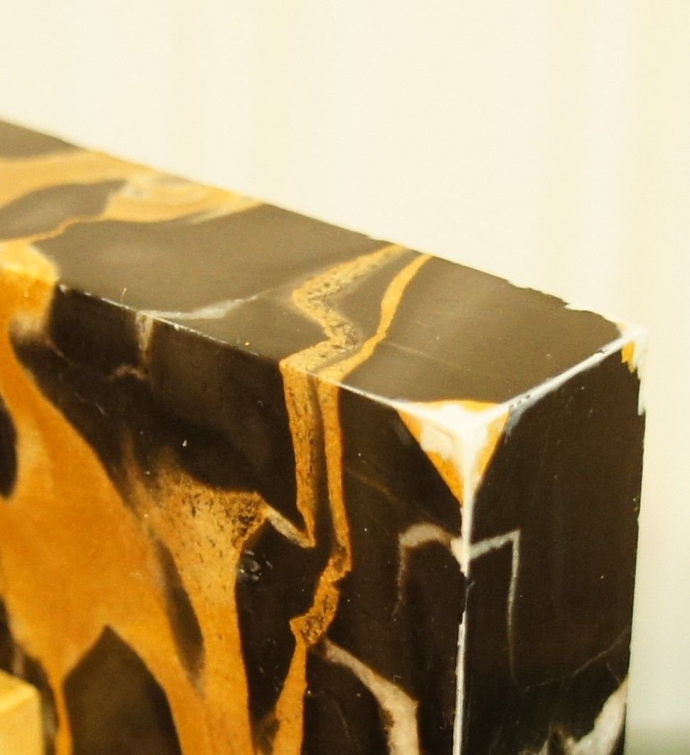 Pair of Portor marble bookends, black and golden yellow