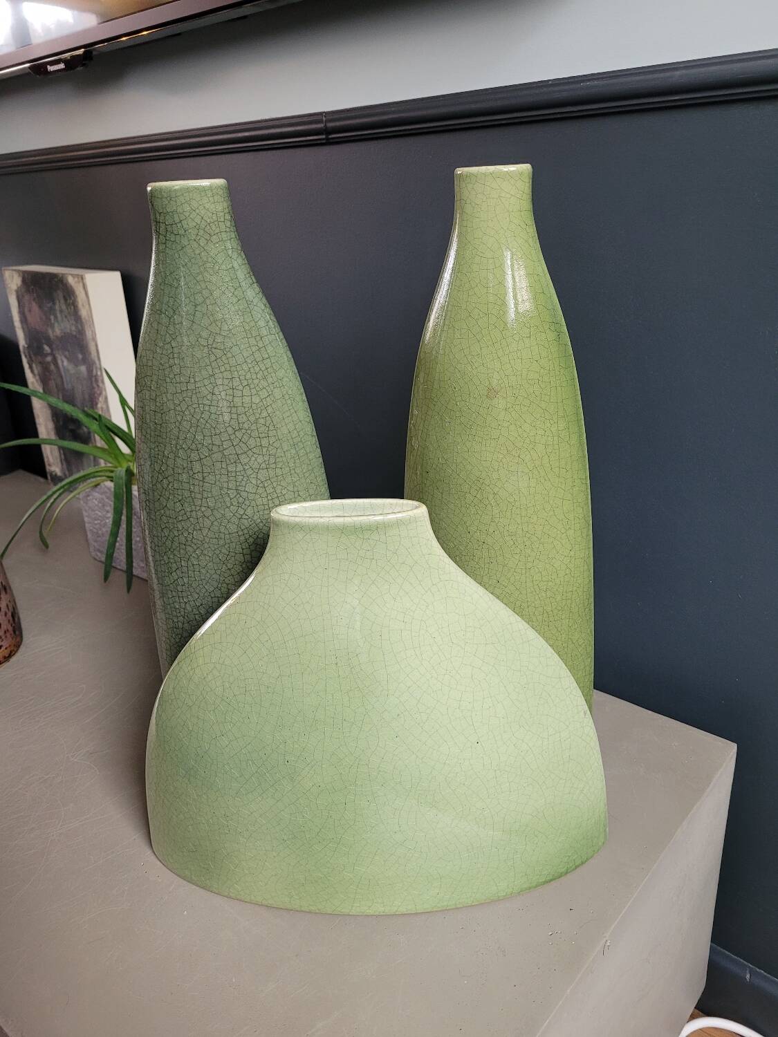 Trio of green enamelled vases