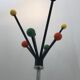 Wearing chrome parrot coat, black and multicolored balls
