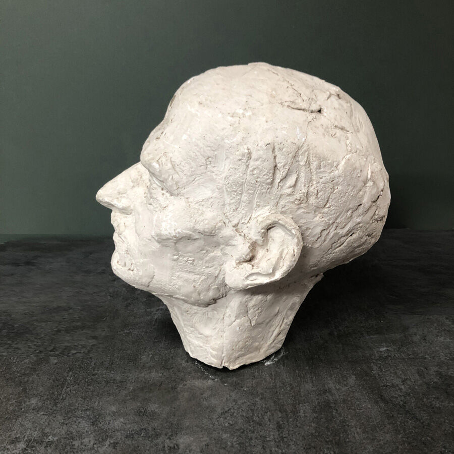 Head of a man with a plaster mustache