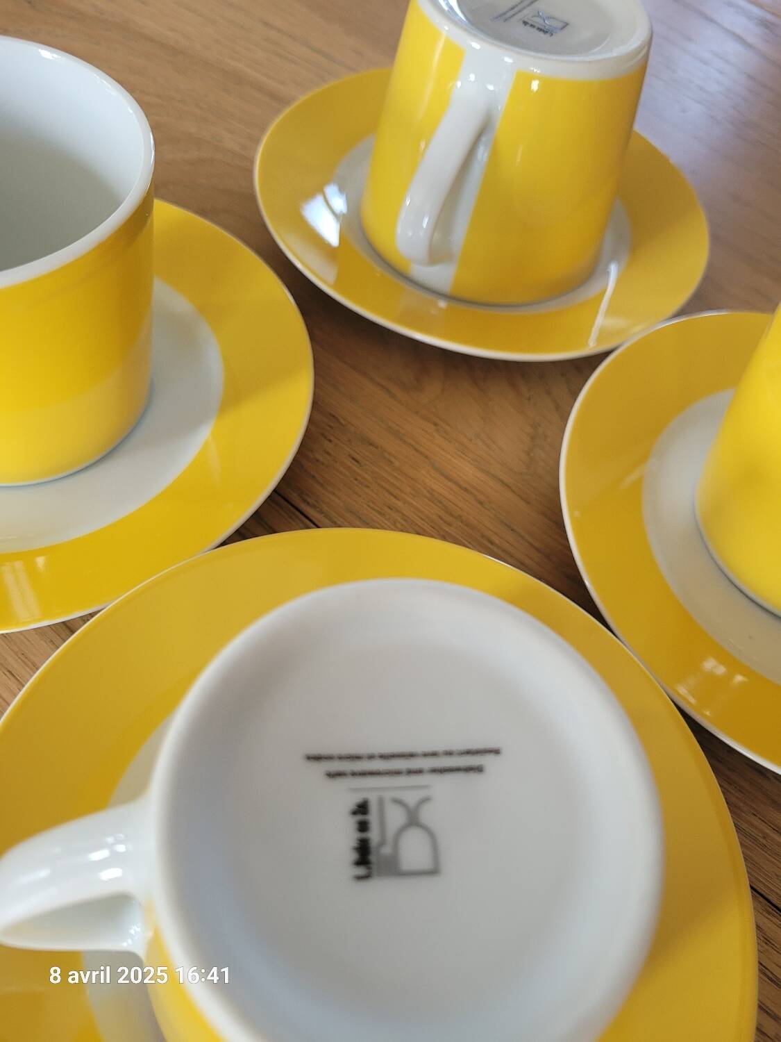 4 yellow and white cups and saucers