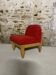 Vintage armchair in red fabric and light wood.