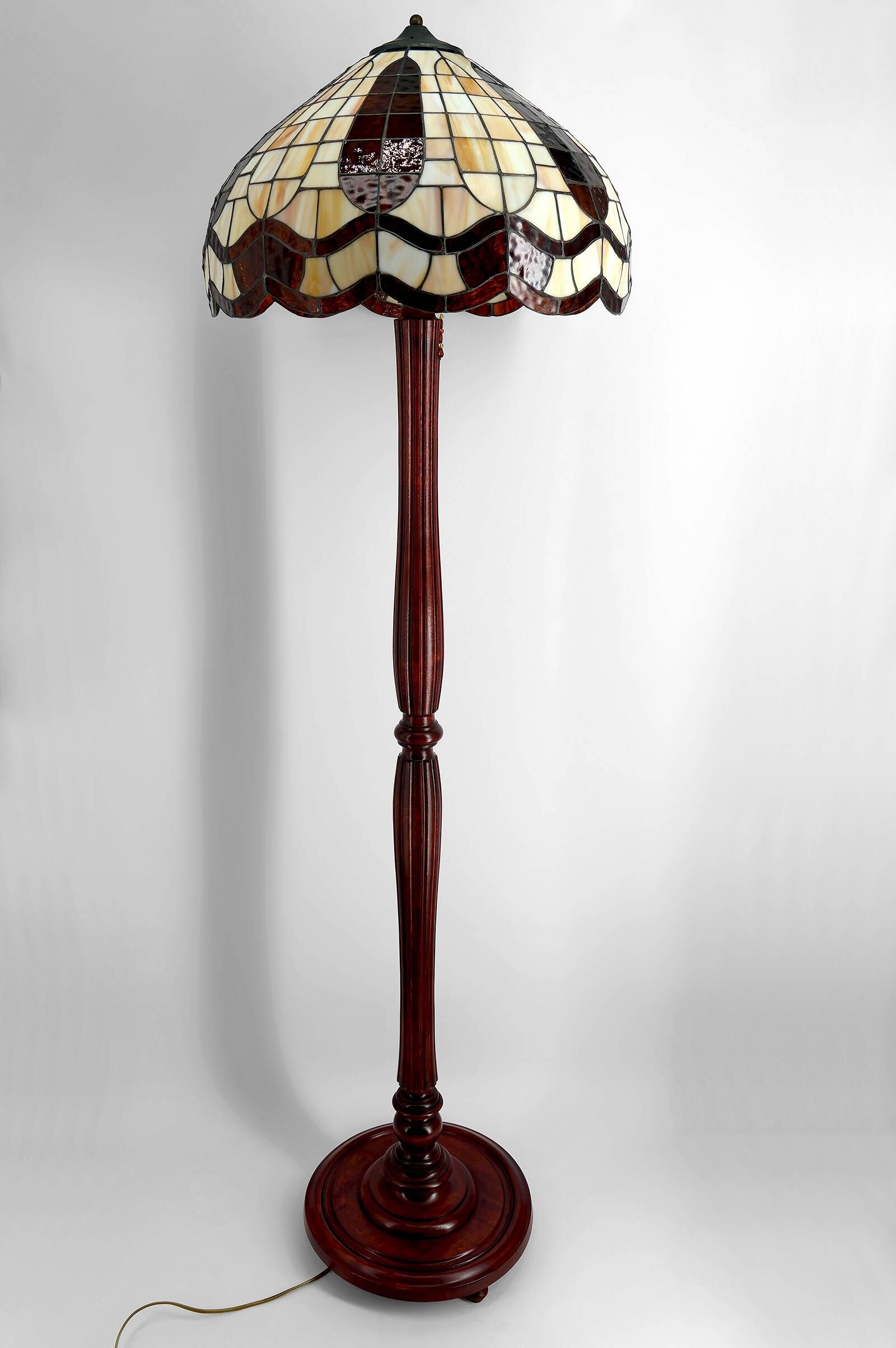 Art Deco floor lamp in carved walnut, stained glass shade, France, c. 1920