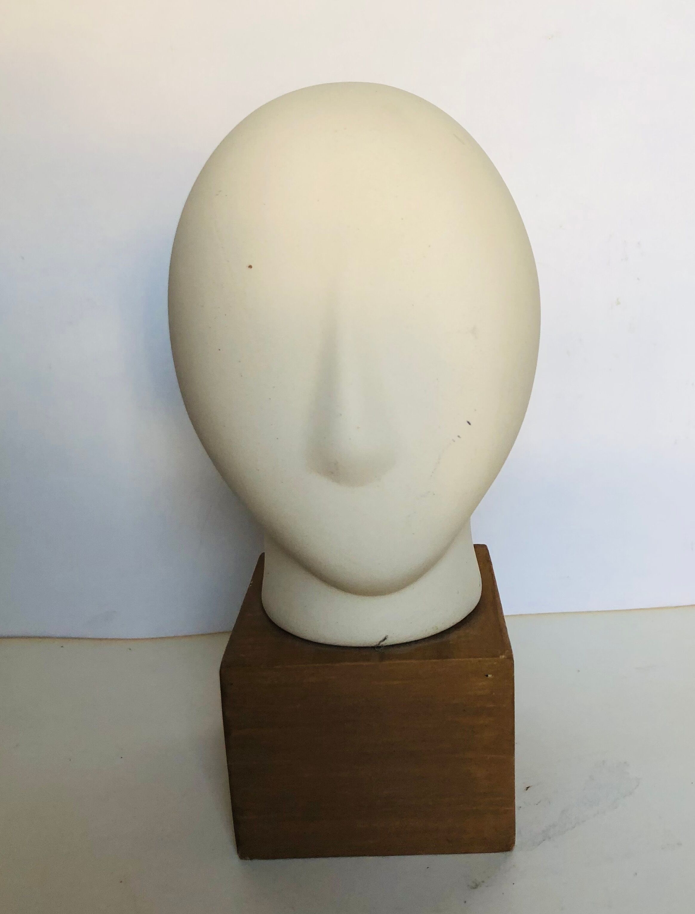 Ceramic head on wooden base