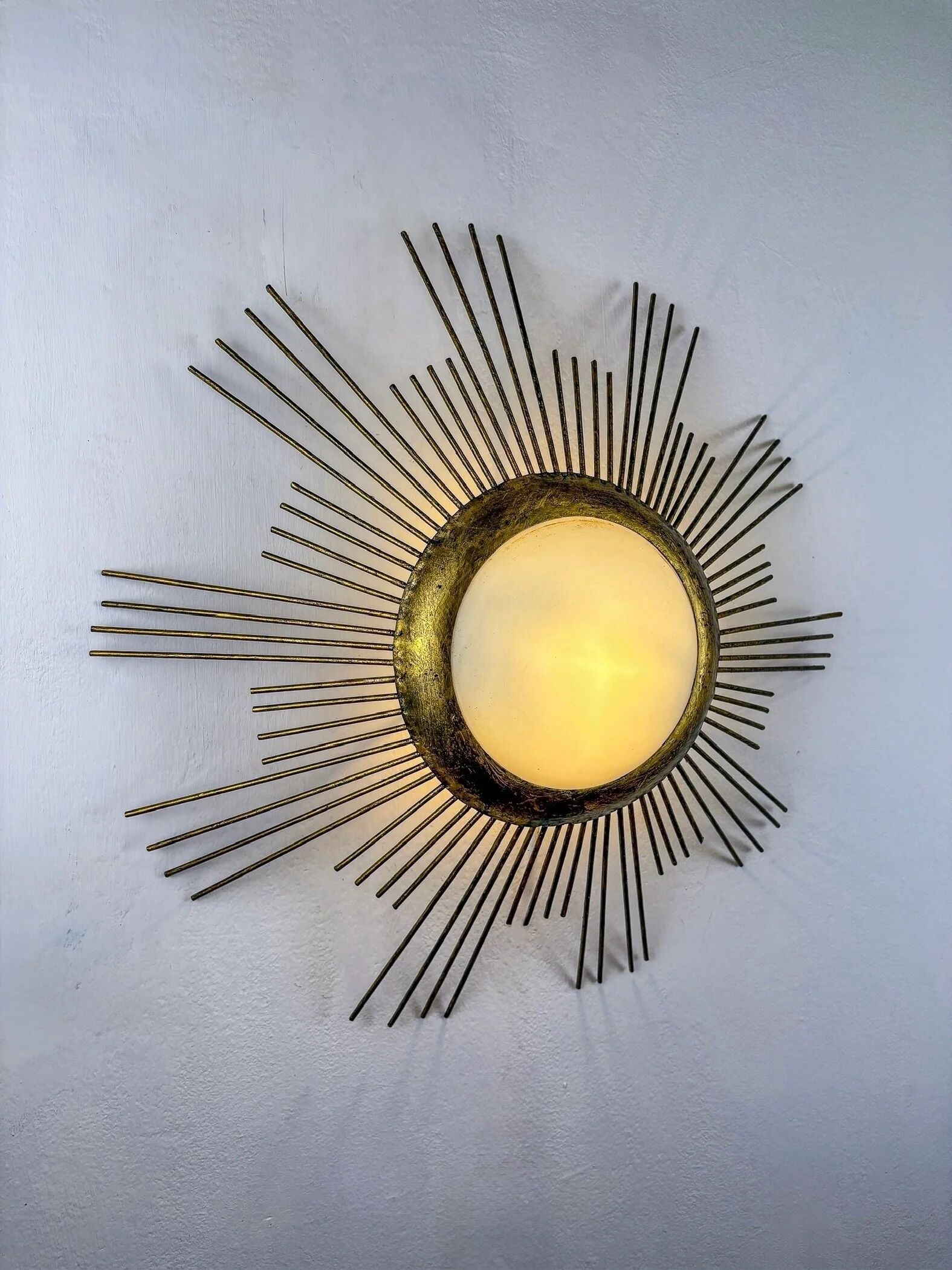 Large sunburst brutalist ceiling flush mount or pendant – gilt iron rays & opaline, France, 1950s