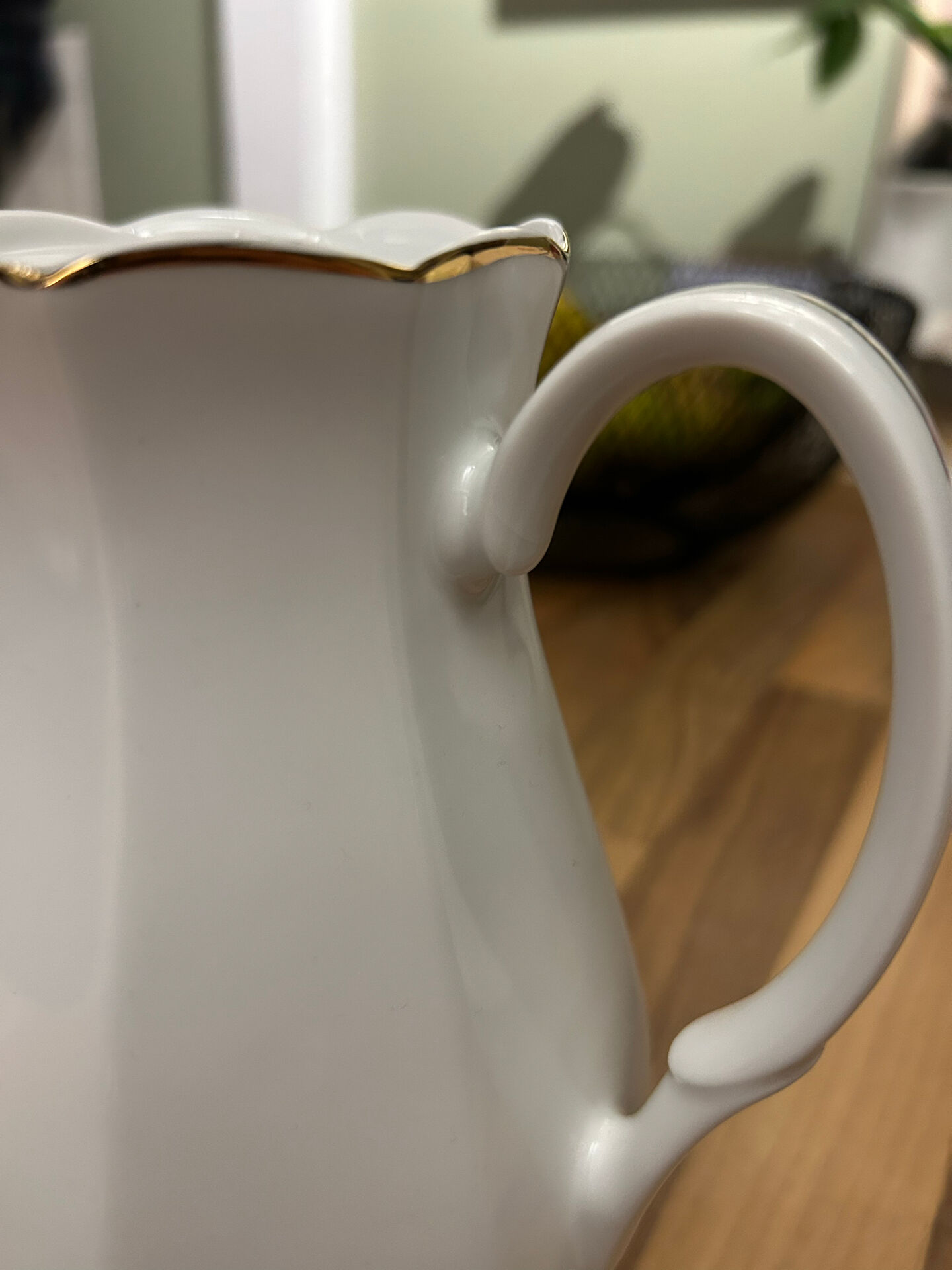Vintage coffee pot in white porcelain with a gold trim.