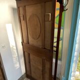 Antique wooden coat rack with mirror and shelf.