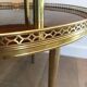 Tripod gueridon in neoclassical style made of mahogany, brass, and a golden metal base.