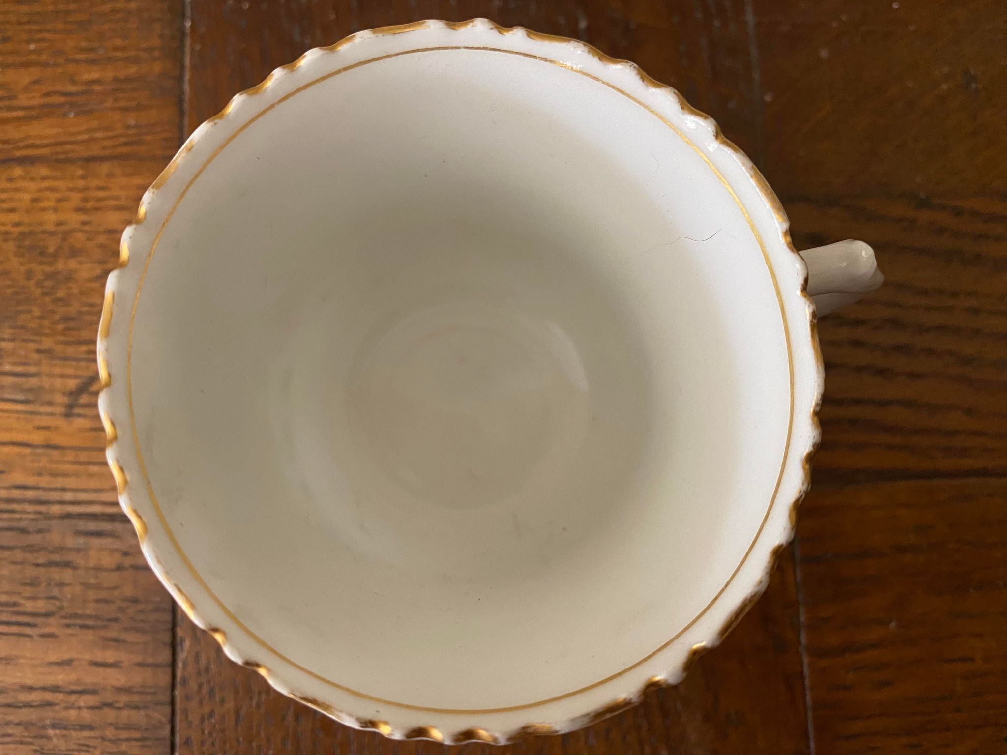 Porcelain cup with chiseled and gilded rim