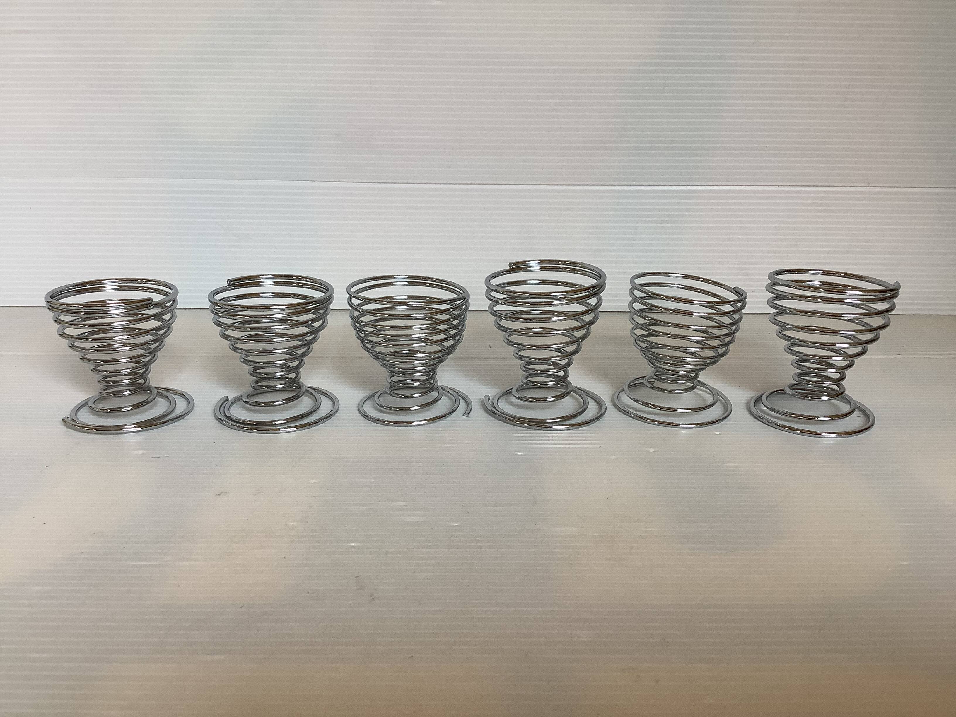 Six metal spiral spring egg cups