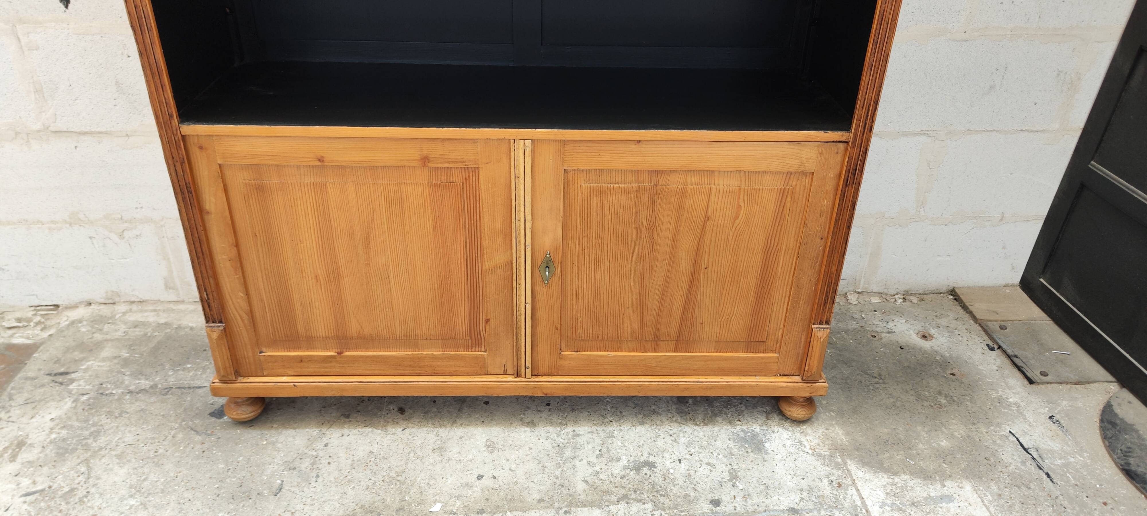 Large waxed pine bookcase with two doors