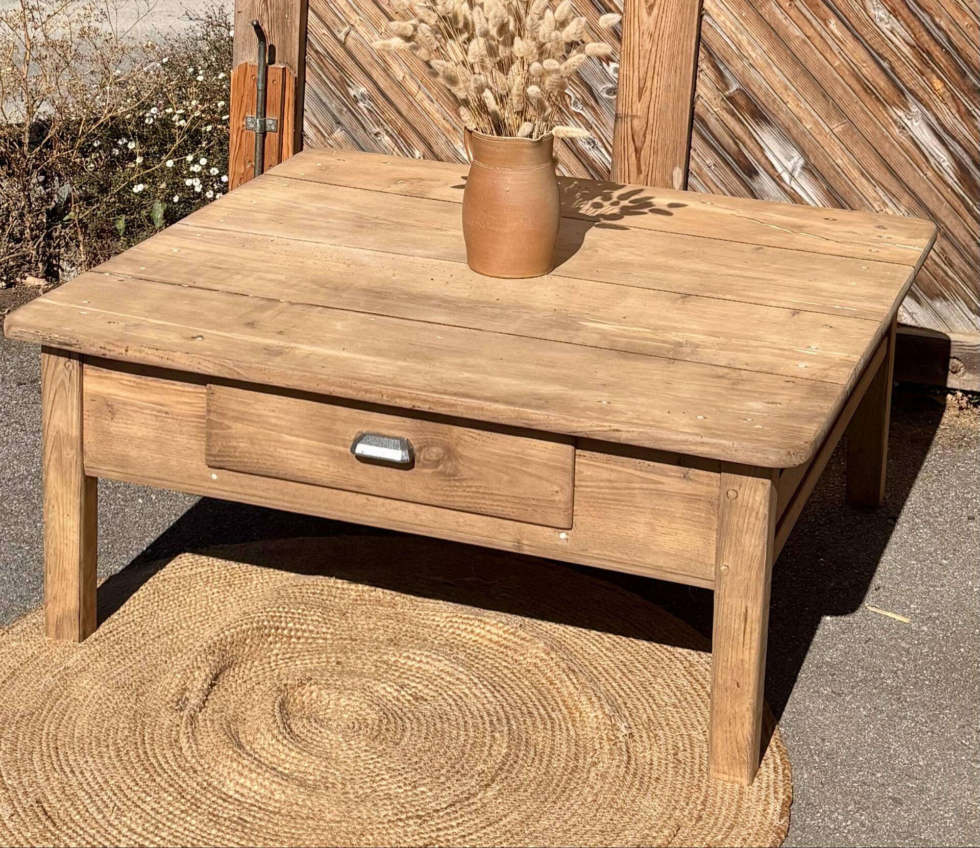 Large square farmhouse coffee table made of raw solid oak.