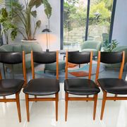 4 Scandinavian chairs in teak and black faux leather.