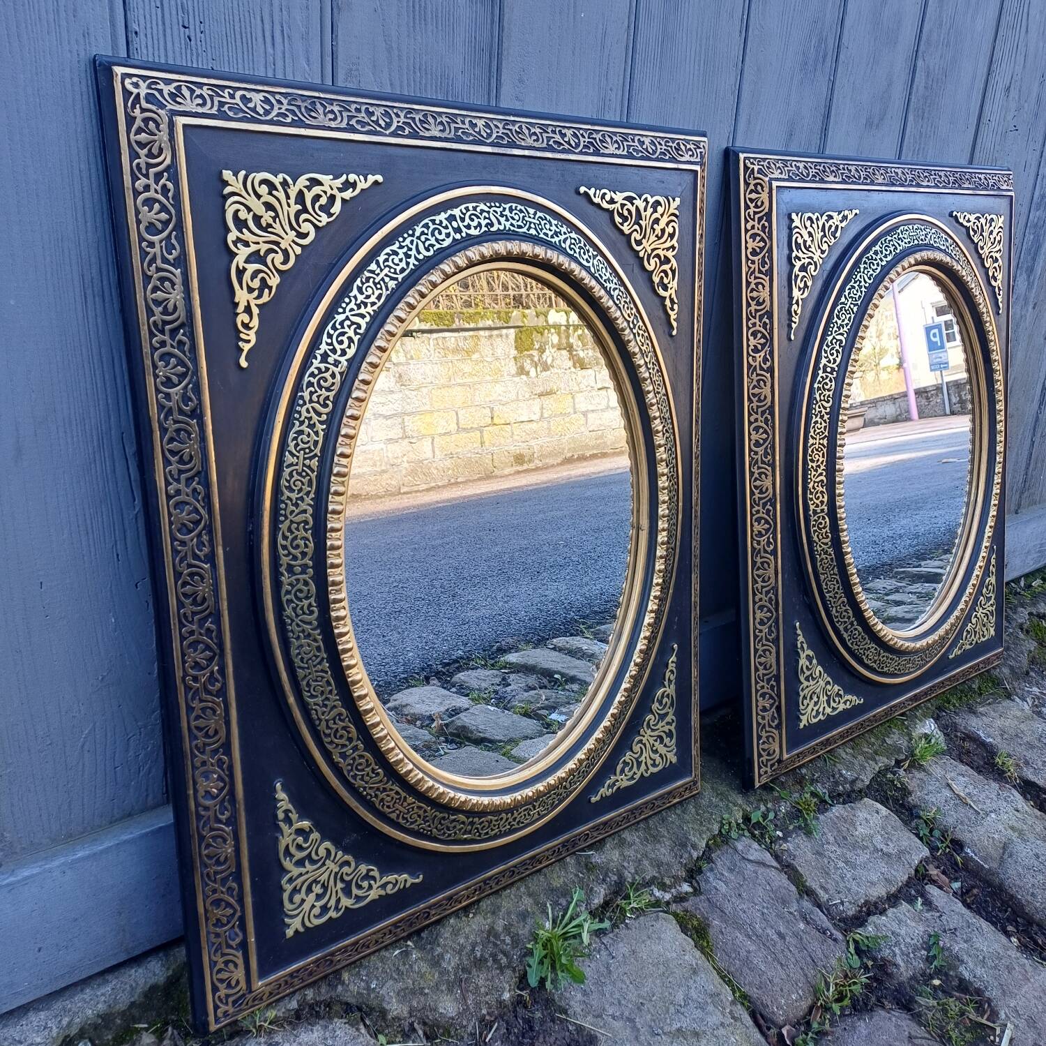 Pair of antique mirrors from the Napoléon III period, black and gilded.